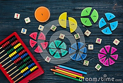 Creative Ð¡olorful math fractions on dark background. Interesting funny math for kids. Education, back to school Stock Photo